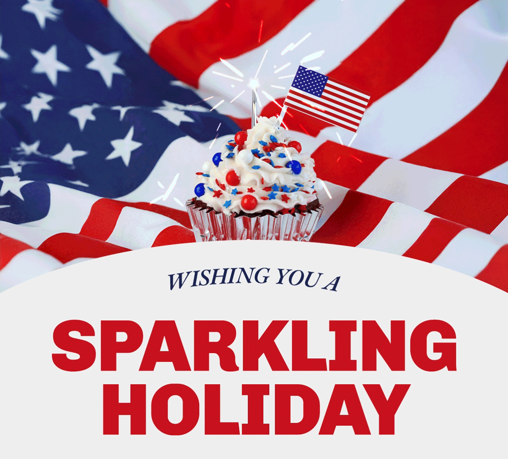 A cupcake topped with white frosting, red and blue sprinkles, a sparkler and a small American flag. The cupcake is on a background of a larger American flag. Wishing you a Sparkling Holiday text across the bottom of the image.